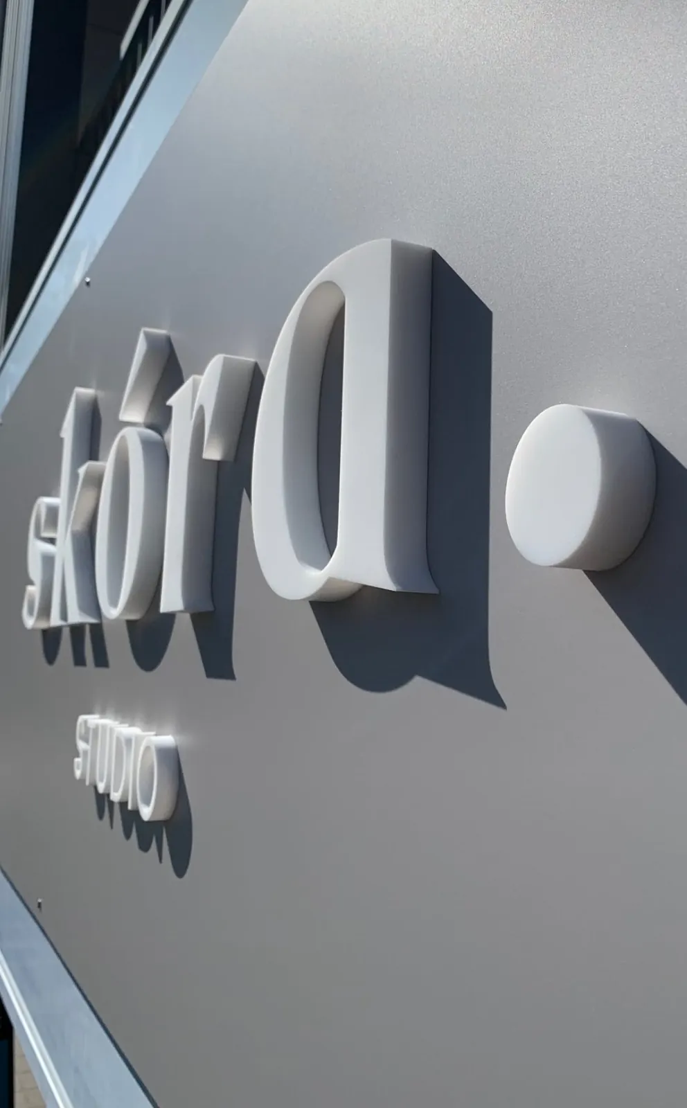 Skóra Studio raised white acrylic 3D letters on fascia panel by Sykes Signs