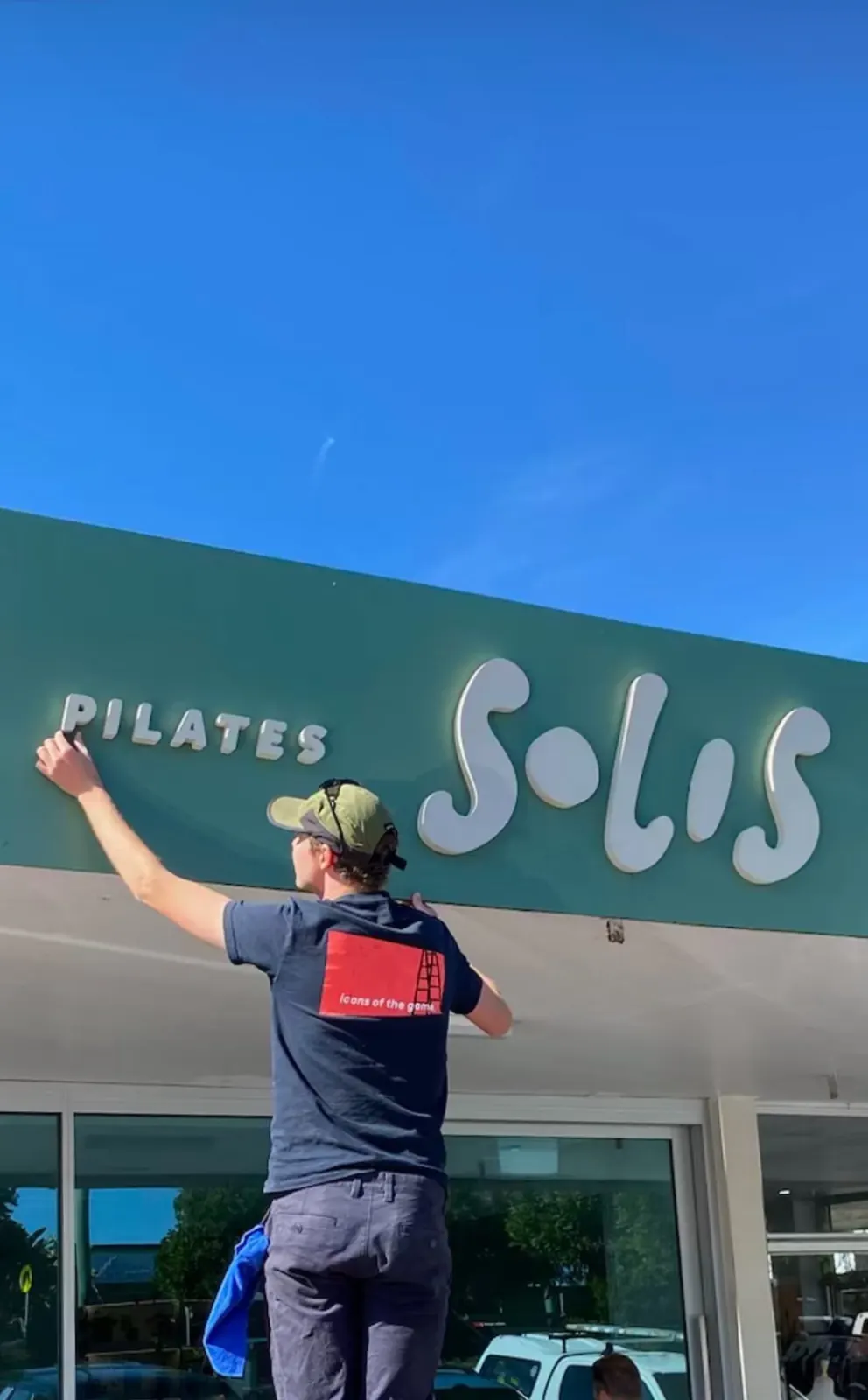 Sykes Signs installer fitting Solis Pilates 3D letters on site